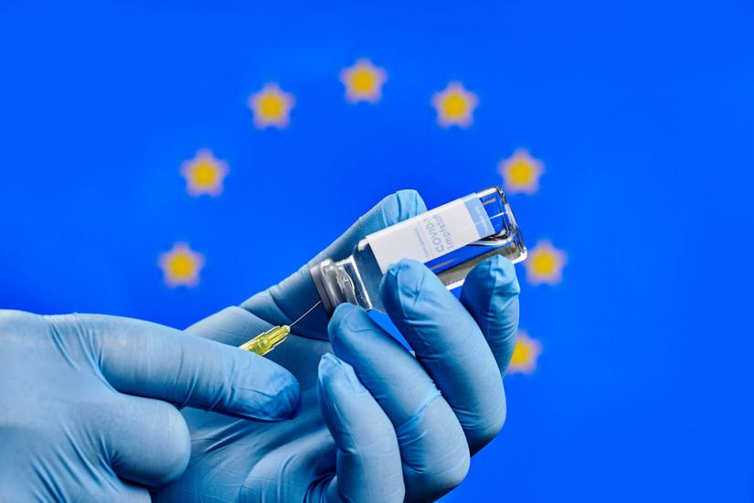 Doctor preparing Covid-19 injection against the European Union flag by Marco Verch under Creative Commons 2.0